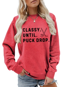 Detail of red crewneck sweatshirt with Classy Until Puck Drop hockey print and ribbed cuffs