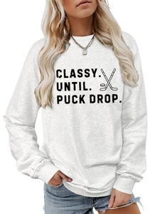 Detail of Classy Until Puck Drop letter print and ribbed cuffs on a white sweatshirt