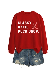 Detail of red hockey sweatshirt with Classy Until Puck Drop slogan and graphic print