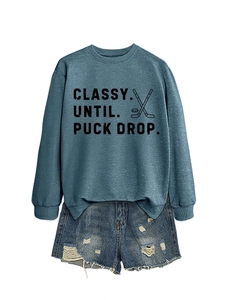Navy crewneck sweatshirt with PUCK DROP print and distressed denim shorts layout