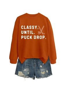 Burnt orange sweatshirt with 'Classy Until Puck Drop' text and distressed denim shorts