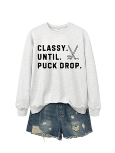 Detail of printed grey sweatshirt and distressed denim shorts with classy text and sticks
