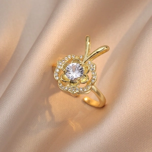 Golden rose adjustable open ring with sparkling zircon stone on luxury silk background