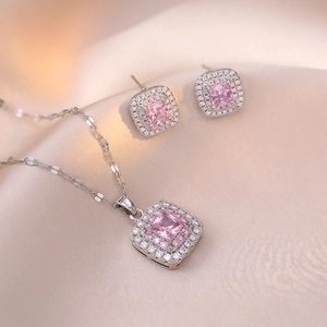 Elegant pink square gemstone jewelry set with necklace and earrings on champagne silk