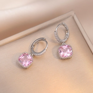 Elegant silver drop earrings featuring a radiant cushion cut pink zircon on a display box