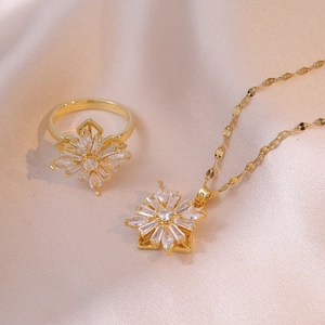Golden sunburst jewelry set with necklace and ring featuring sparkling clear zircons