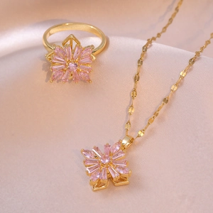Elegant gold titanium necklace and ring set with spinning pink zircon flower pendant