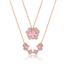 Rose gold necklace with clover pendant transforming into four hearts with pink stones