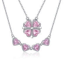 Detail of magnetic heart clover necklace showing transformation to four-leaf clover