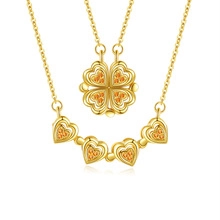 Detail of s925 gold-plated necklace showing foldable heart or four-leaf clover transformation