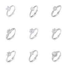 Detail view showing nine assorted cut silver rings with marquise and emerald stones
