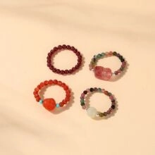 Detailed view of four handmade bohemian beaded elastic rings with garnet and stones