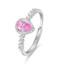 Detail of elegant pear-cut pink zircon ring with pavé micro-inlays in silver finish