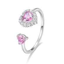 Detail of silver adjustable ring featuring dual pink heart crystals with diamond halo