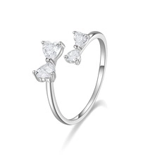 Close-up of S925 sterling silver bow ring featuring four heart-shaped zircon stones