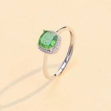 Macro detail of a 925 silver ring featuring a green square gemstone and adjustable band
