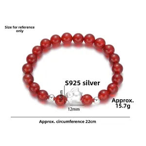 Close-up of S925 silver bunny charm and natural red agate beads on a beaded bracelet