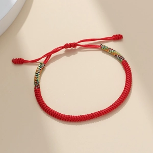 Handmade woven red cord bracelet with colorful silk accents and adjustable slider knot