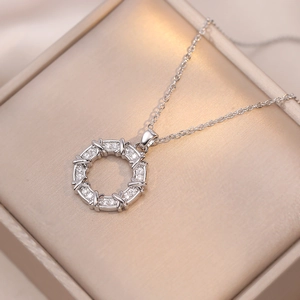 Elegant cubic zirconia donut pendant necklace in titanium steel on champagne jewelry box