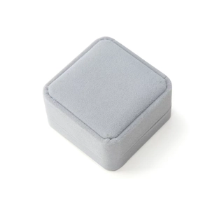 Close-up of a premium gray velvet square jewelry box for elegant pearl earrings