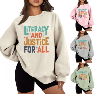 Detail showing various colors of loose fit sweatshirts with literacy slogan print
