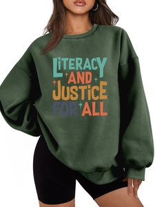 Detail of loose-fit dark green fleece sweatshirt with Literacy and Justice print