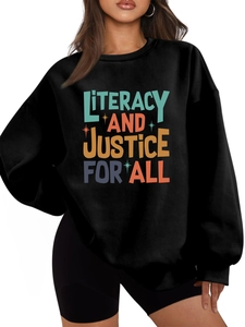 Detail of a black round neck sweatshirt with colorful Literacy and Justice print