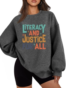 Close-up of Literacy and Justice for All print on a dark gray warm sweatshirt