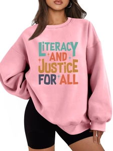 Detail of pink sweatshirt featuring Literacy and Justice For All colorful graphic art