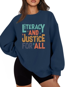 Detail of navy fleece sweatshirt featuring colorful Literacy and Justice for All print