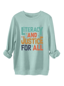 Detail of rolled cuffs and colorful artistic lettering on mint green sweatshirt