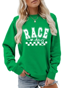 Close-up of green loose sweatshirt featuring Race Day print and ribbed cuffs