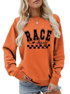 Detail of orange Race Day sweatshirt with ribbed cuffs and checkered flag print