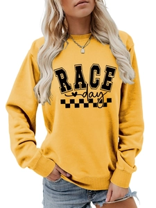 Close-up of yellow sweatshirt featuring Race Day text and checkered flag graphic print