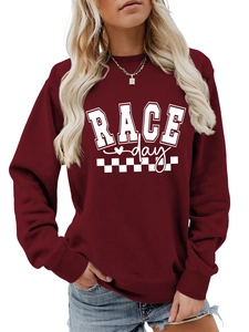 Detail of burgundy Race Day sweatshirt with white checkered flag print and ribbed cuffs