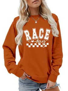 Detail of burnt orange sweatshirt with RACE day text and racing flag pattern