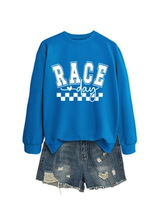 Flat lay of a bright blue Race Day sweatshirt paired with distressed denim shorts