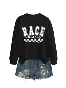 Detail of Race Day graphic sweatshirt paired with distressed denim shorts on white background