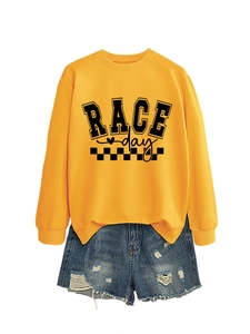 Flat lay of yellow Race Day racing sweatshirt with distressed denim shorts