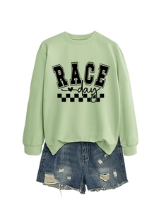 Flat lay of light green Race Day sweatshirt paired with distressed denim shorts