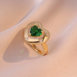 Adjustable gold open heart ring with green zircon and star engraving on silk background