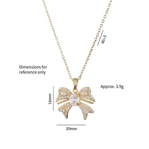 Elegant gold bow pendant necklace with sparkling cubic zirconia on a minimalist chain