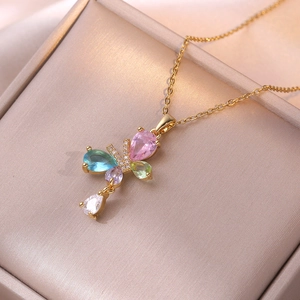 Elegant butterfly pendant necklace with colorful pear-cut zircons on champagne satin background