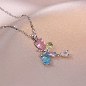 Elegant silver necklace with colorful pear-cut zircon butterfly pendant on silk fabric