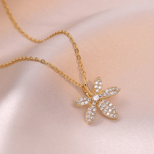 Elegant gold flower pendant necklace with clear zircon pavé setting on pink satin