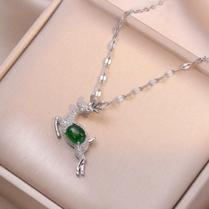 Silver reindeer pendant necklace with emerald green stone and sparkling zircon accents