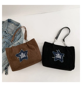 Detail of suede tote bags with denim star patch and metal chain shoulder straps
