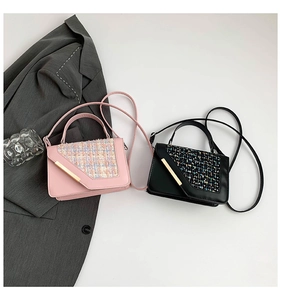 Detail of pink and black crossbody bags with tweed flap and gold metal bar buckle