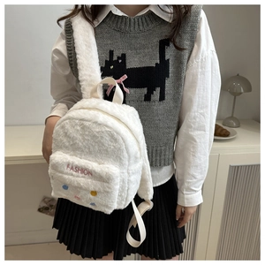 Close-up of white plush backpack featuring fashion embroidery and colorful buttons