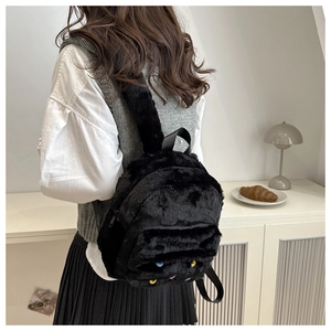 Detail view of the plush black backpack back with adjustable straps and soft texture